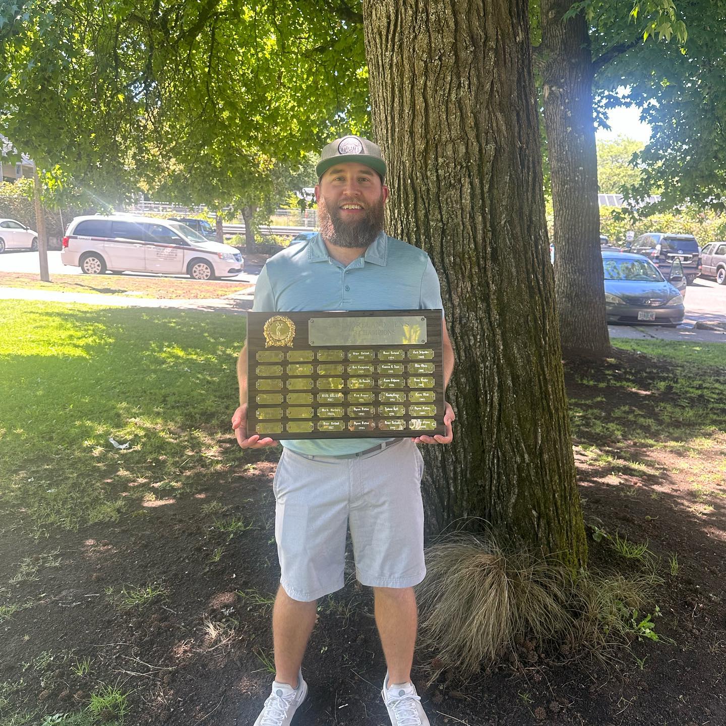 Me, holding the plaque of past winners of the club championship at Eastmoreland