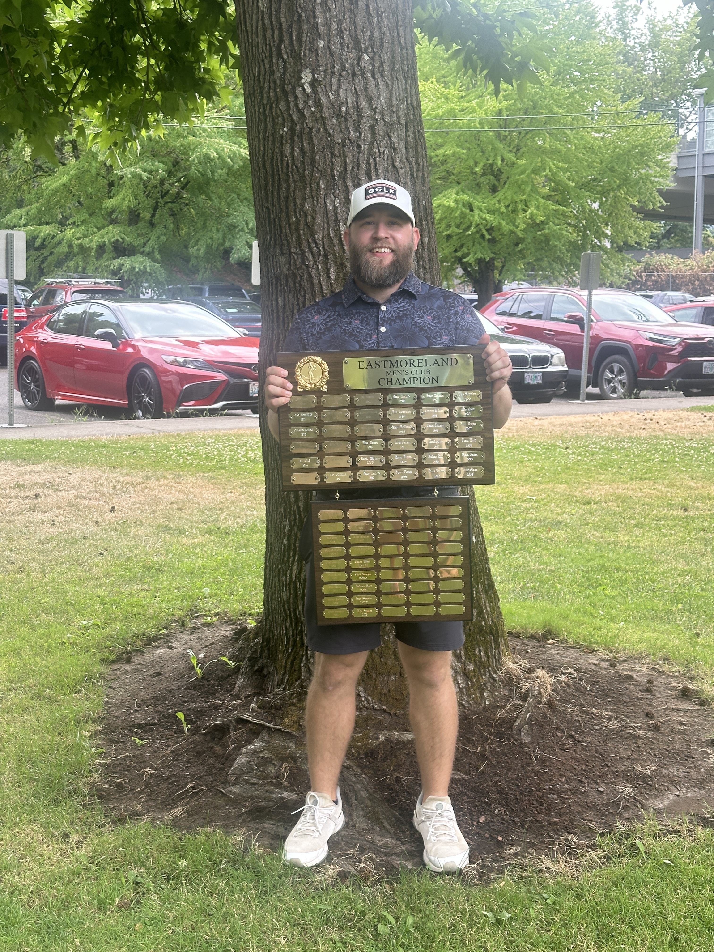 Me, holding the plaque of past winners of the club championship at Eastmoreland